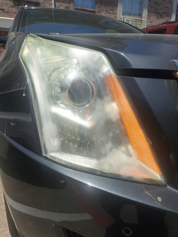 Sedan headlight before restoration, hazy and oxidized