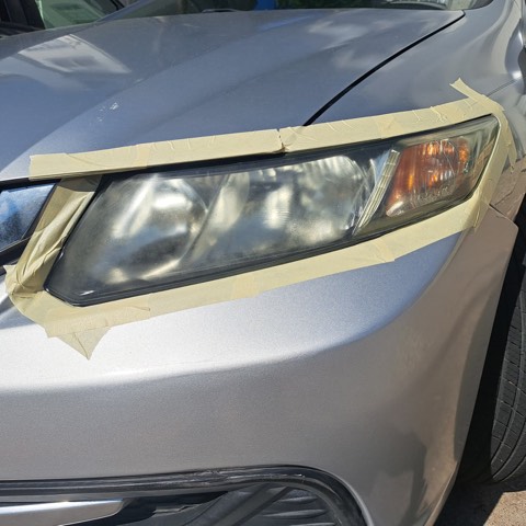 Sedan headlight before restoration, hazy and oxidized