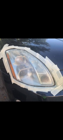 Sedan headlight before restoration, hazy and oxidized