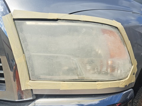 Truck headlight before restoration, hazy and oxidized