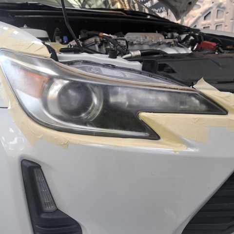 Sedan headlight before restoration, hazy and oxidized