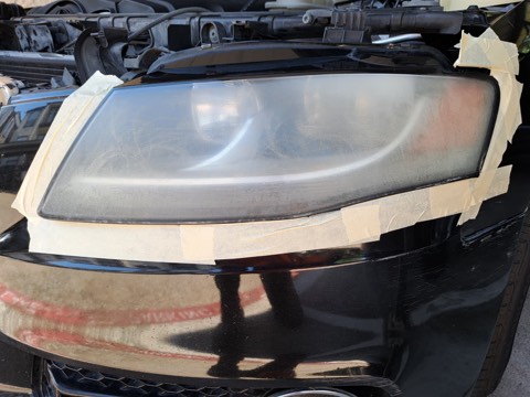 Sedan headlight before restoration, hazy and oxidized