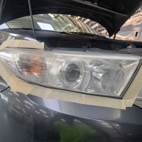 Sedan headlight before restoration, hazy and oxidized