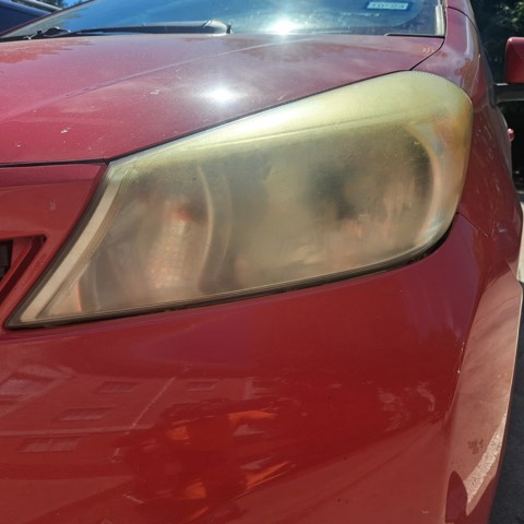 Sedan headlight before restoration, hazy and oxidized
