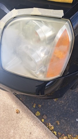 Sedan headlight before restoration, hazy and oxidized