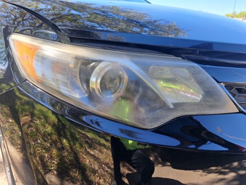 Sedan headlight before restoration, hazy and oxidized