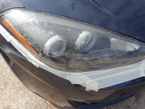 Sedan headlight before restoration, hazy and oxidized