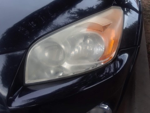Sedan headlight before restoration, hazy and oxidized