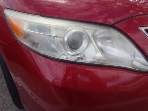 Sedan headlight before restoration, hazy and oxidized
