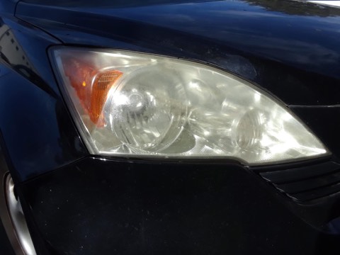 Sedan headlight before restoration, hazy and oxidized