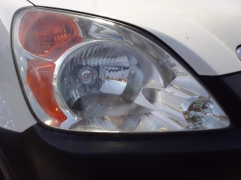 Sedan headlight before restoration, hazy and oxidized