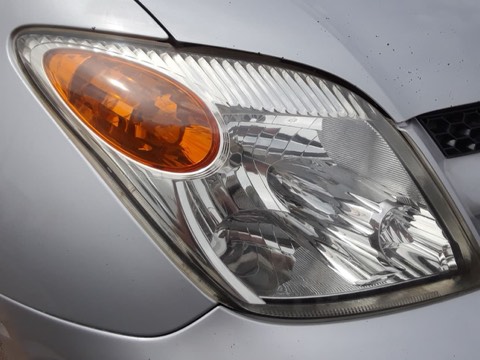Sedan headlight before restoration, hazy and oxidized