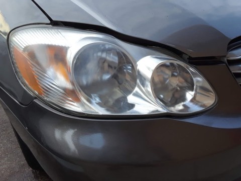 Sedan headlight before restoration, hazy and oxidized