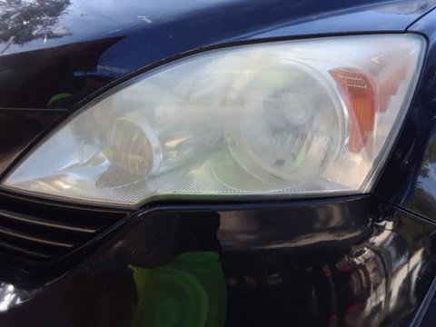 Sedan headlight before restoration, hazy and oxidized