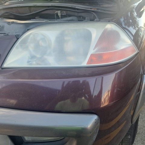 SUV headlight before restoration, hazy and oxidized