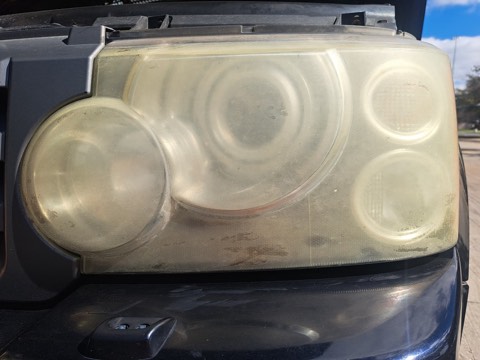 Truck headlight before restoration, hazy and oxidized