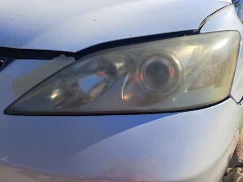 Sedan headlight before restoration, hazy and oxidized