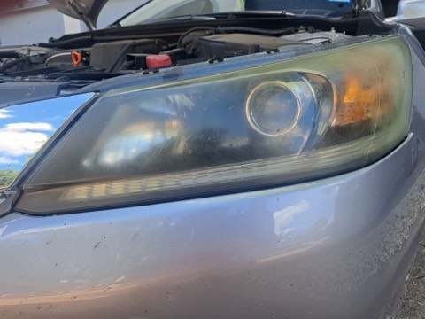 Sedan headlight before restoration, hazy and oxidized